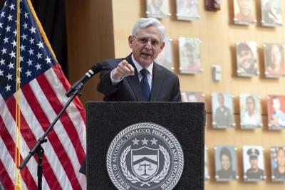 Garland speaks with victims' families as new exhibit highlights the faces of gun violence