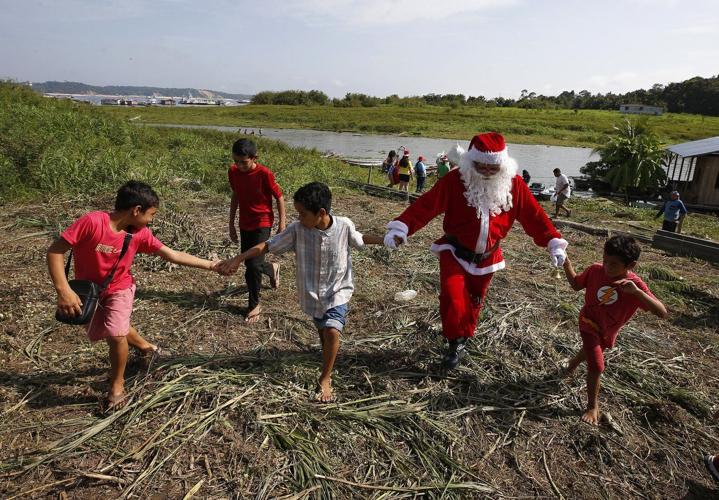 Santa braves the sticky heat of the Amazon jungle to bring gifts to children in Brazilian village