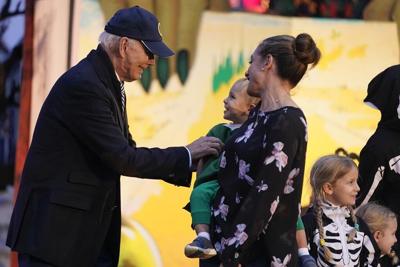 Biden and Jill Biden hand out books and candy while hosting thousands for rainy trick or treating