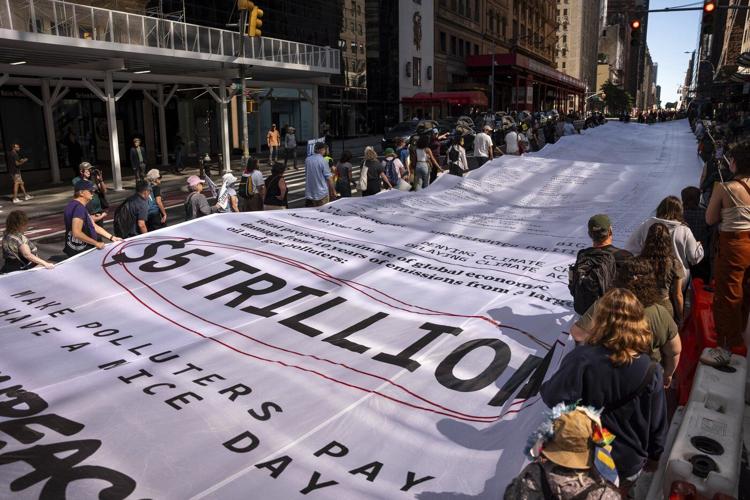 Photos show activists targeting billionaires in a street protest on the eve of New York Climate Week