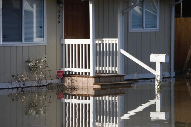 Arctic air sweeps south as residents of the Pacific Northwest remain on guard after severe flooding