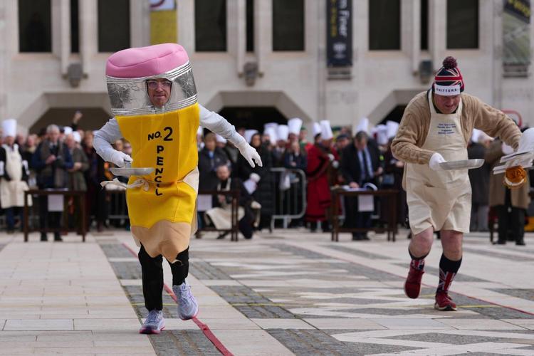Photos of Londoners in costume sprinting with frying pans on Pancake Day