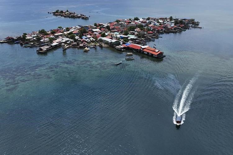 Panama community pushed from Caribbean island by rising sea levels moves into new houses