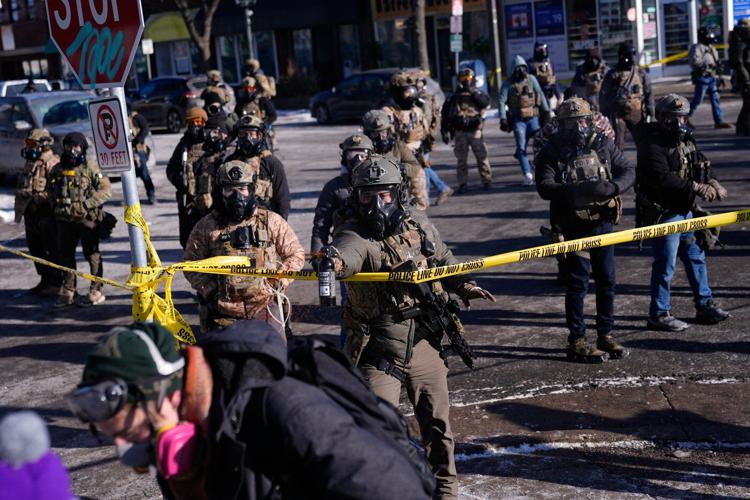 Officers react with crowd after man was killed in Minneapolis amid immigration crackdown, in photos