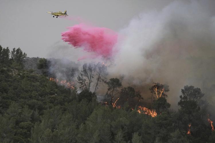 A wildfire closes main highway linking Tel Aviv to Jerusalem and sends 12 people to the hospital