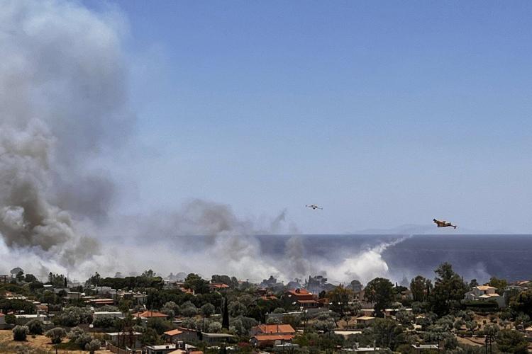 Wildfire prompts evacuations near Athens as summer's first heat wave hits Greece