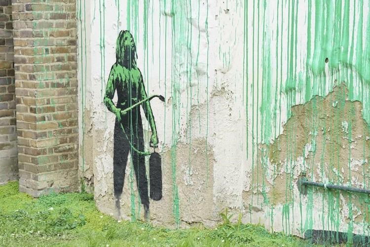 A new Banksy mural sprouts beside a cropped tree in London. Many see an environmental message