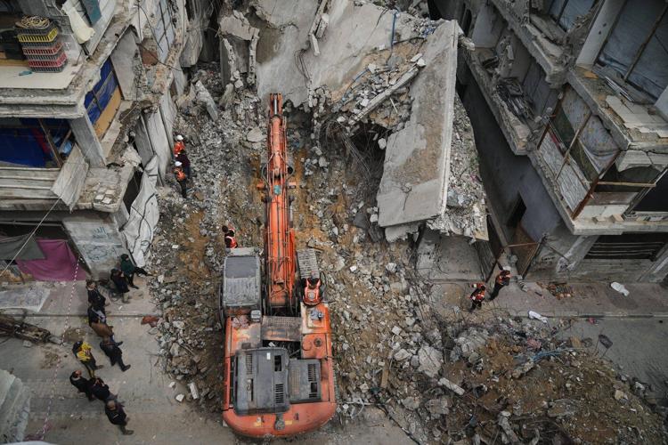 A father in Gaza searches for his family's bones in the rubble of their home
