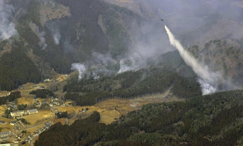 Japan fights a forest fire that has damaged dozens of homes and caused hundreds to evacuate