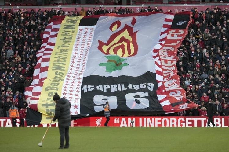 The UK apologizes to families of 97 Liverpool soccer fans killed after a stadium crush 34 years ago