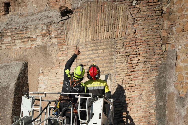 Rescuers work to reach worker trapped in medieval tower that partially collapsed in Rome