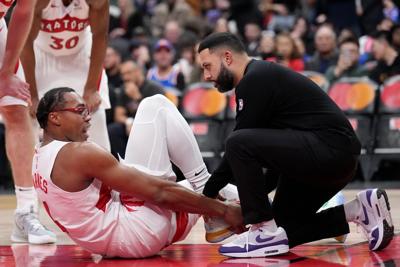 Scottie Barnes wearing air cast boot to protect sprained right ankle