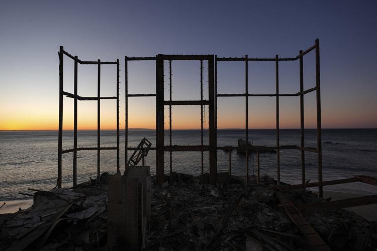 Firefighters report progress against LA blazes as winds pick up again