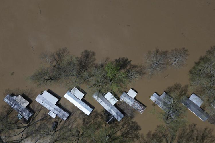 Kentucky watches for surging rivers to recede so widespread cleanup can begin