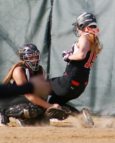 Corry's Shannon Baker slides into the GC catcher to score the go-ahead run.