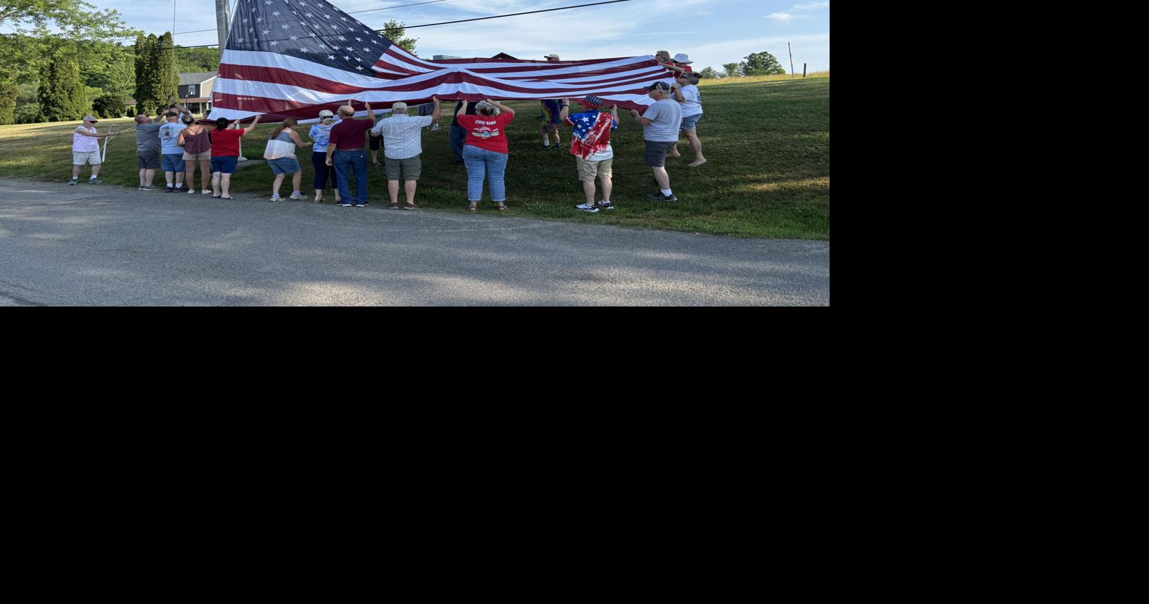 Volunteers raise huge flag at NEB for the Fourth of July