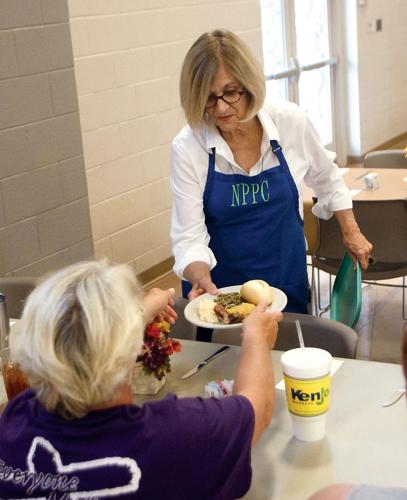 Volunteer Judy Simon serves food at the Welcome Table at New Providence Presbyterian Church