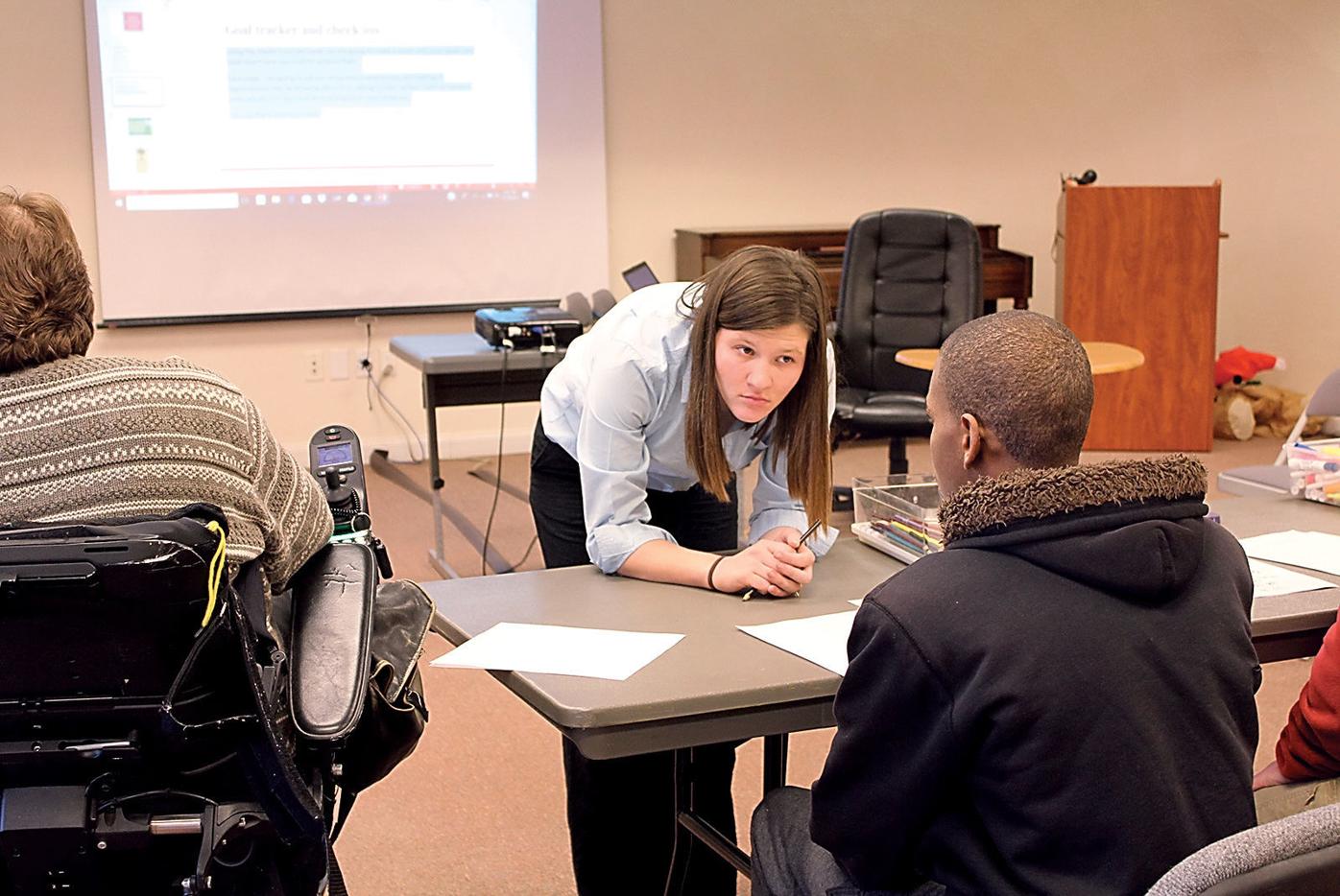 Maryville College senior Molly Ridgeway, center, listens to a student during a lesson