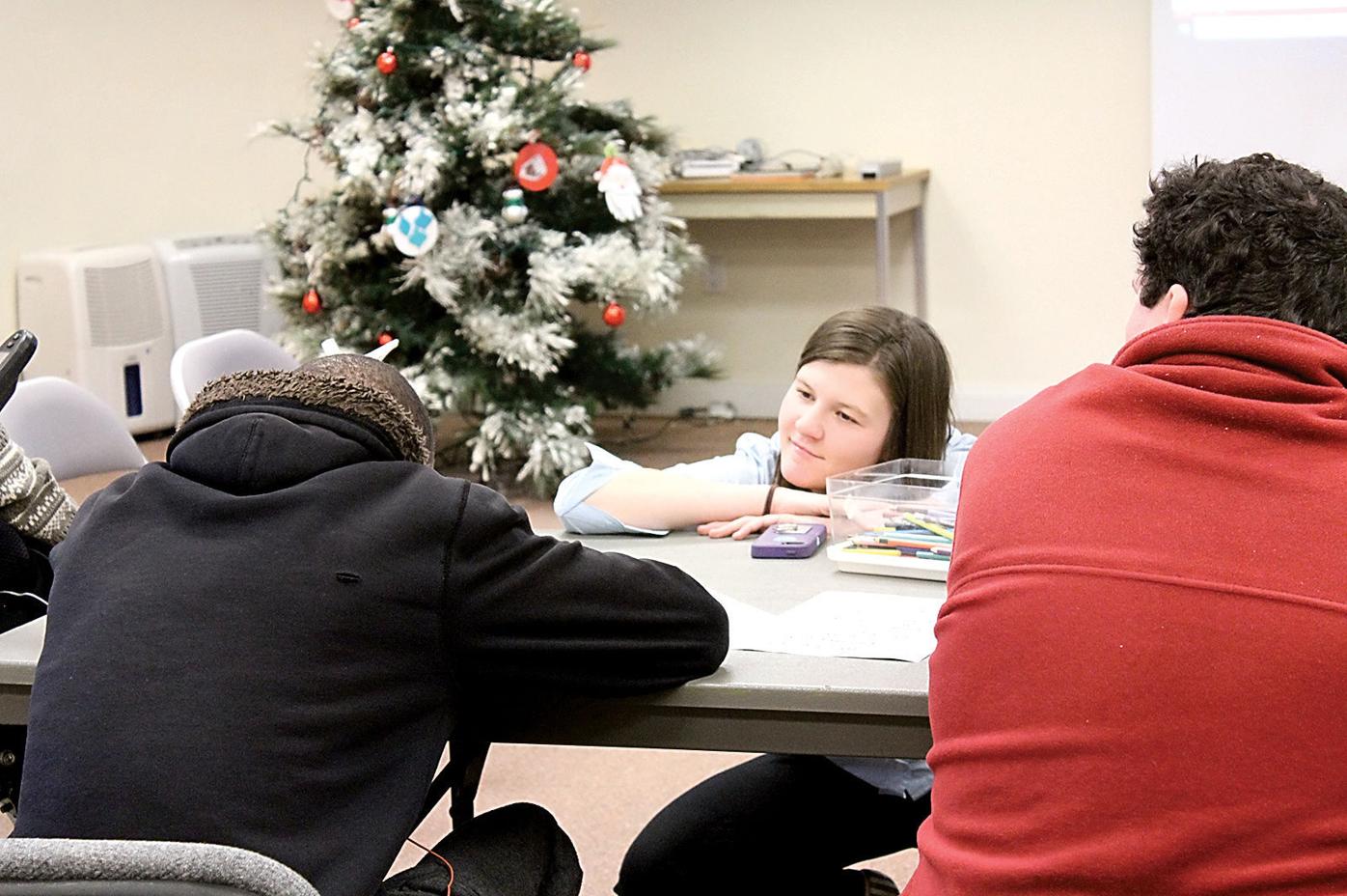 Molly Ridgeway, center, listens to a student during a lesson Ridgeway taught at ETTAC