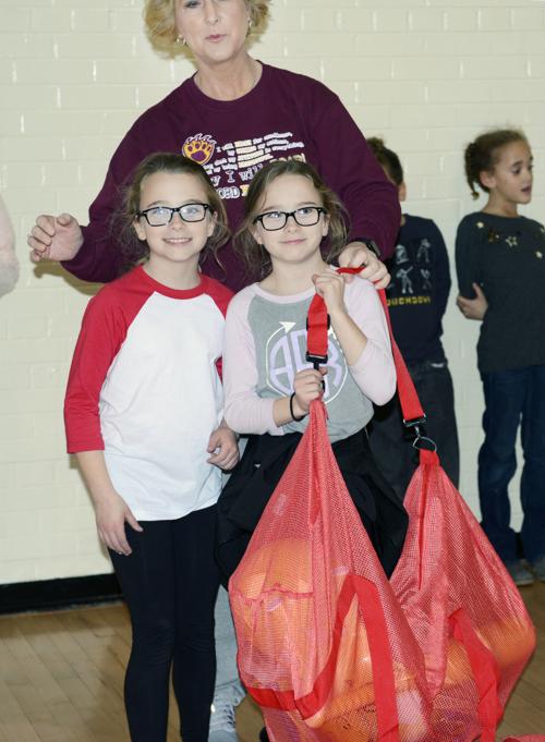 Rockford Elementary School’s Foister twins carry PE at Home bag