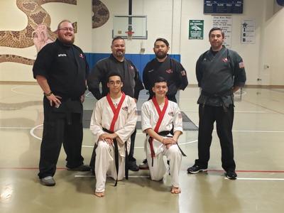 Area students earn first-degree black belts