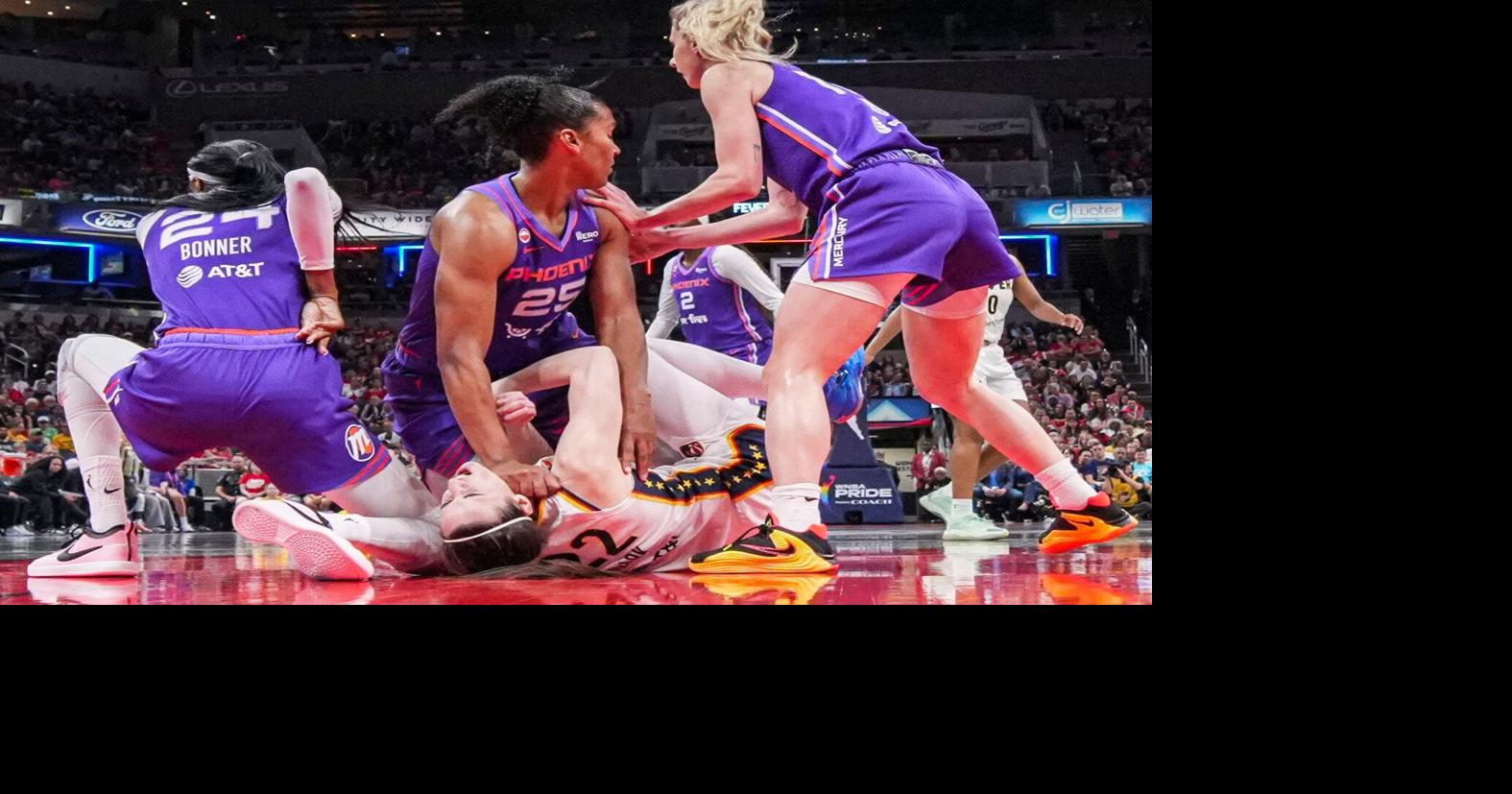 Phoenix Mercury forward Alyssa Thomas (25) scrambles to get up over Indiana Fever guard Caitlin Clark (22) on Wednesday, June