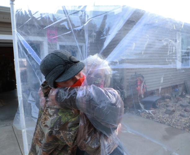 Palmer boys install hugging wall to hug grandparents during COVID-19  pandemic