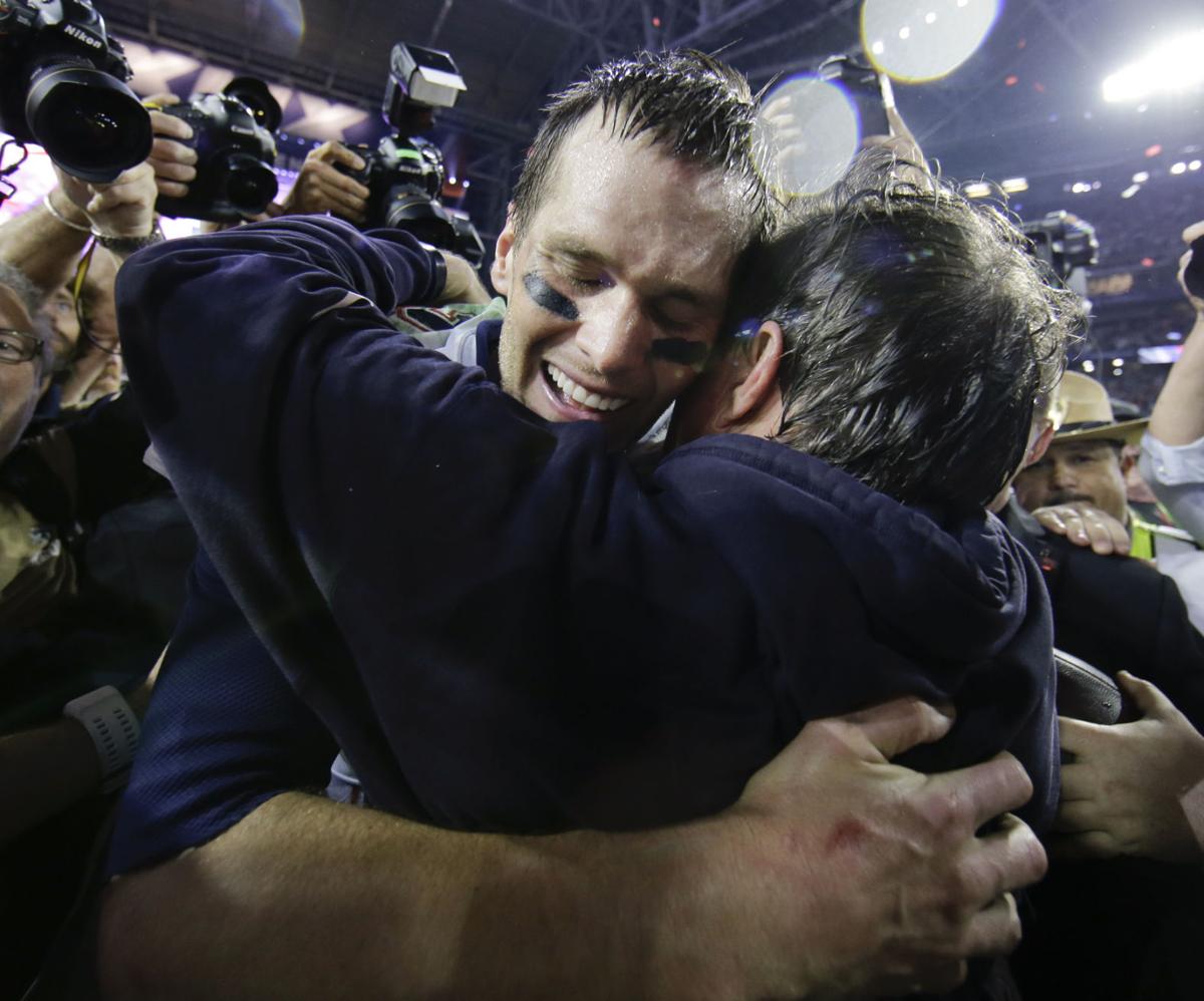 New England Patriots quarterback Tom Brady (12) celebrates with head coach Bill Belichick.