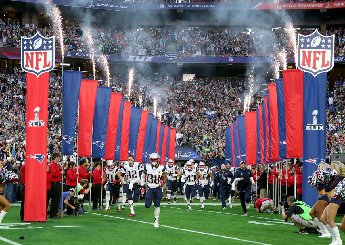 The New England Patriots take the field before the start of Super Bowl XLIX.
