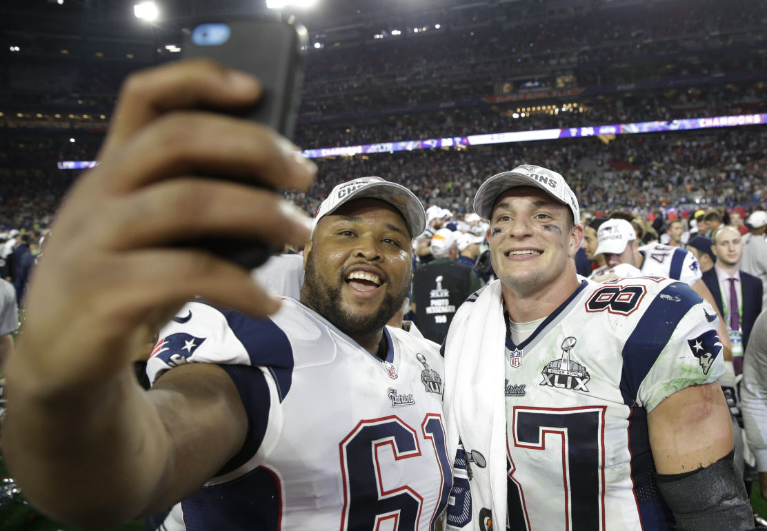 New England Patriots guard Marcus Cannon (61) takes a selfie with Rob Gronkowski (87).
