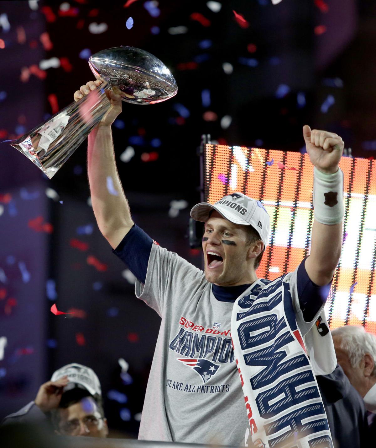 New England Patriots quarterback Tom Brady (12) celebrates with the Vince Lombardi trophy after defeating the Seattle Seahawks in Super Bowl XLIX in Glendale, Ariz.