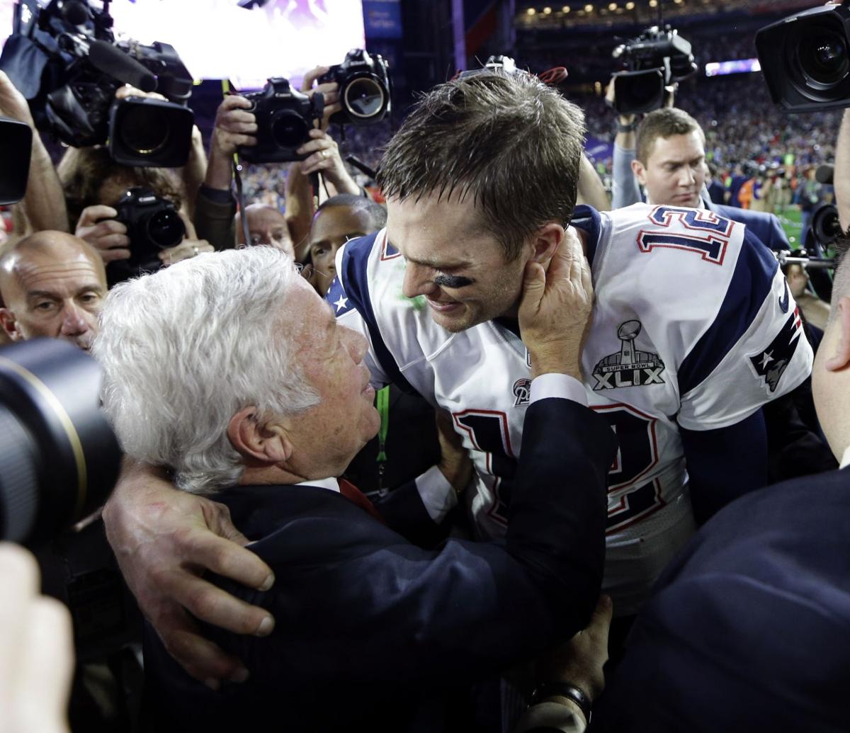 New England Patriots quarterback Tom Brady (12) celebrates with owner Robert Kraft.