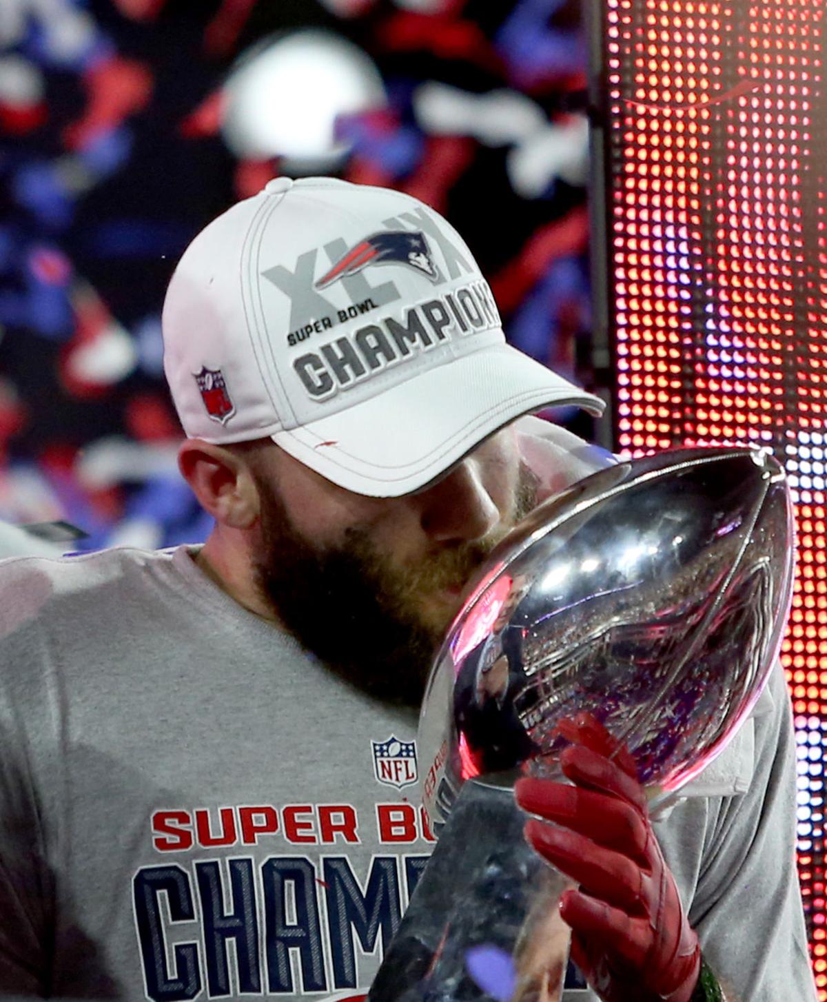 New England Patriots' Julian Edelman kisses the trophy after defeating the Seattle Seahawks 28-24.