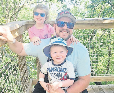 Kyle Hack poses with his children, Laura and Carter.