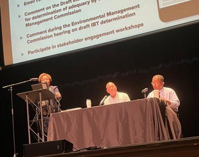 Charlotte Water Director Angela Charles speaks to the crowd during Monday's meeting at CoMMA concerning the utility's request to nearly double the amount of water Charlotte takes from the Catawba Basin each day. Seated are Deputy Director Ron Hargrove a...
