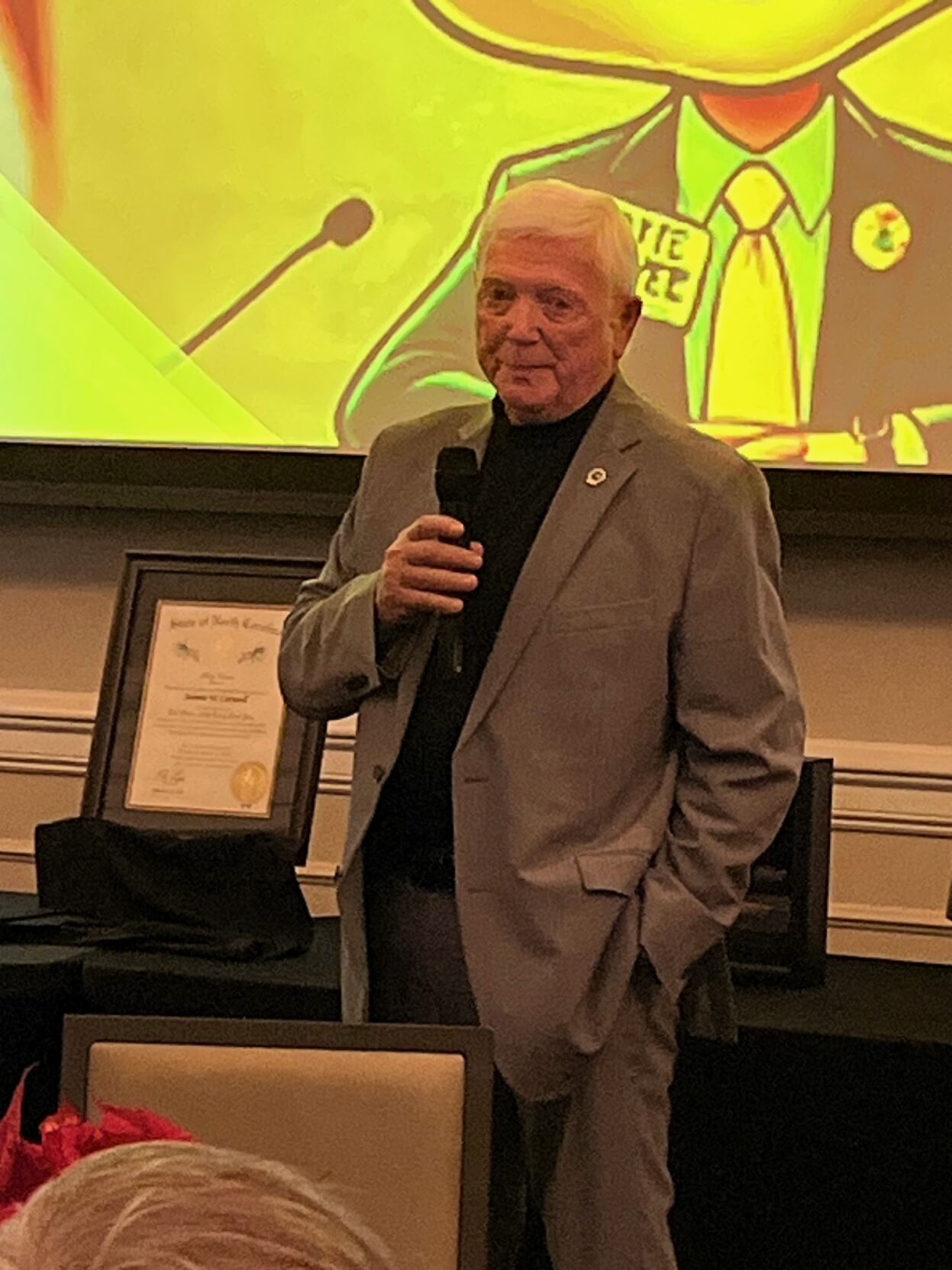 Outgoing Burke County Commissioner Johnnie Carswell speaks during a reception honoring his service and that of fellow commissioner Scott Mulwee Friday evening. Behind Carswell is his certificate for the Order of the Long Leaf Pine. The announcement he h...