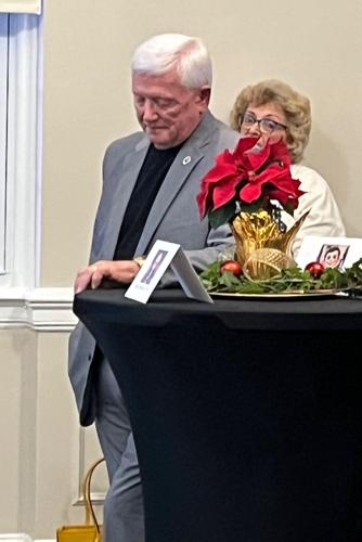 Johnnie Carswell listens to a speaker during an emotional moment at last Friday's reception, held to honor Carswell and fellow outgoing commissioner Scott Mulwee.