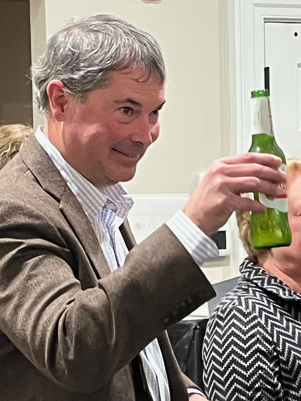 Outgoing Burke County Commissioner Scott Mulwee salutes fellow commissioner Phil Smith during Smith's remarks at a reception for Mulwee and Johnnie Carswell last Friday.