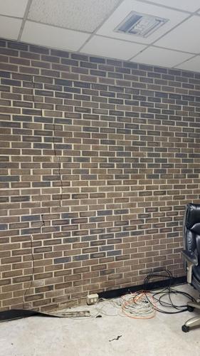 A nearly floor-to-ceiling crack in the bricks