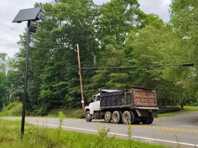 A truck drives by a Flock camera