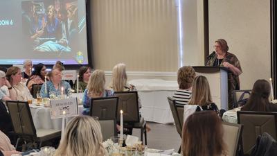Melissa Overton addresses a full room