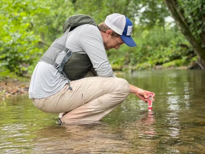 Grant Buckner of Catawba Riverkeeper samples the water in a creek.