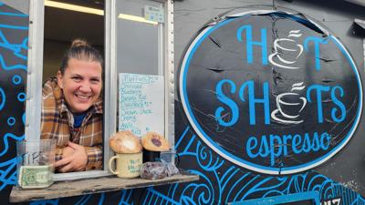 Hot Shots Espresso co-owner Elizabeth Largent stands at the window of the coffee trailer