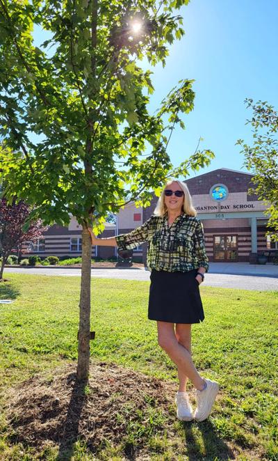 Dr. Melanie Mikusa stands by maple tree dedicated to her late husband