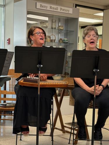 Kathy Cozort, left, and Dr. Kelly S. Taylor sing "I Am a Poor Wayfaring Stranger" during a segment of the Burke Theater Guild's performance Thursday.