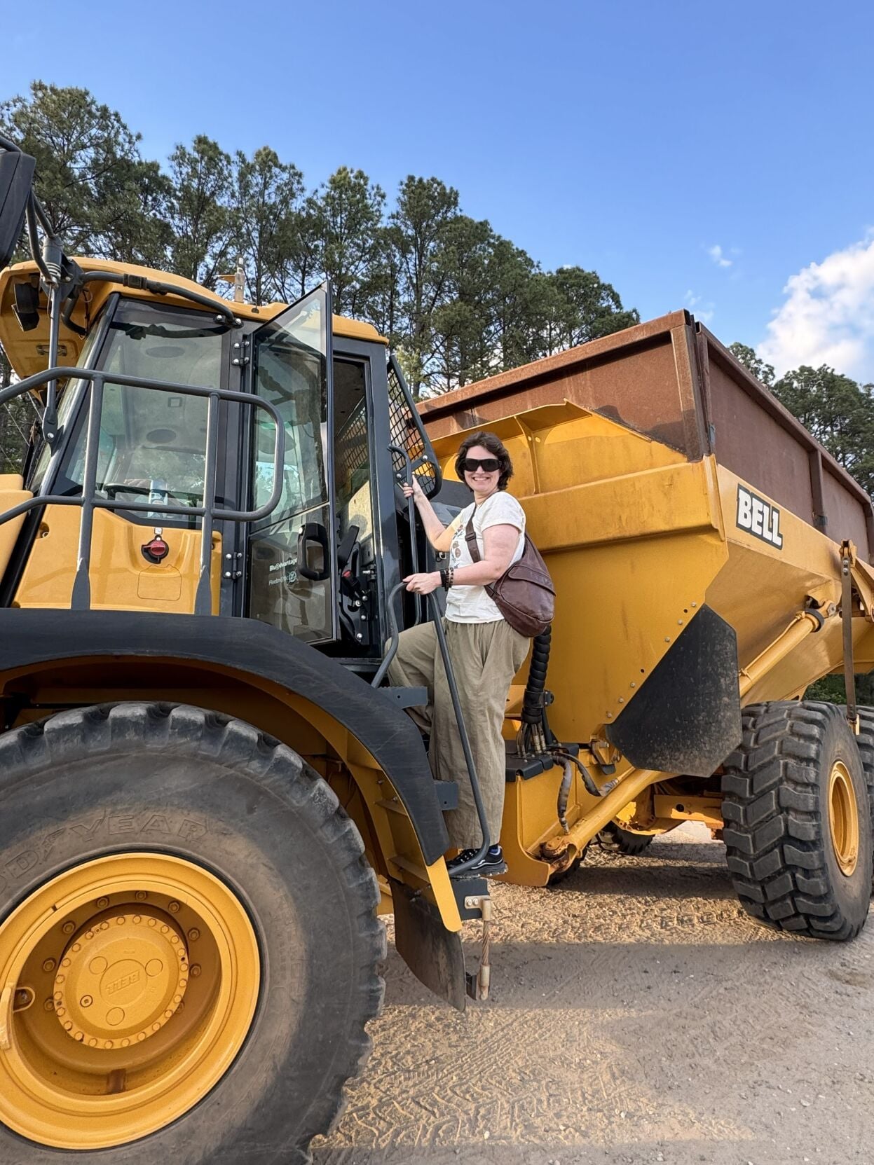 Mica Banks climbs aboard a Burke County dump truck at the landfill