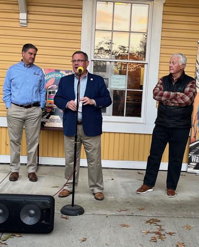 N.C. House Speaker Tim Moore addresses the crowd Tuesday at the second annual Drinks at the Depot celebration hosted by Morganton's Waiting for the Train group, while Sen. Warren Daniel, left, and Rep. Hugh Blackwell await their turns to speak.