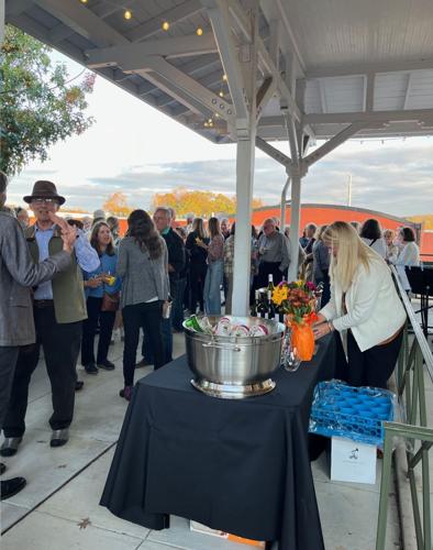 A crowd gathers to enjoy refreshments at the second annual Drinks at the Depot Tuesday evening at the Morganton Depot.