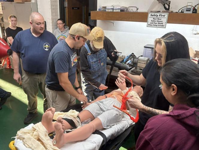 Burke EMS personnel James Deal, left, and Faith Anderson, second from right, teach trauma care at one of the department's monthly educational programs.
