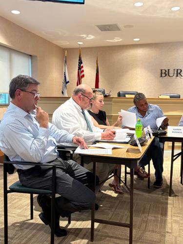 Members of the Burke County Opioid Settlement Committee look over the agenda at the group's inaugural meeting Tuesday in the commissioners boardroom. From left ae Dr. Anthony Frank, Sheriff Banks Hinceman, Katie Olsen, and Karen Russell.